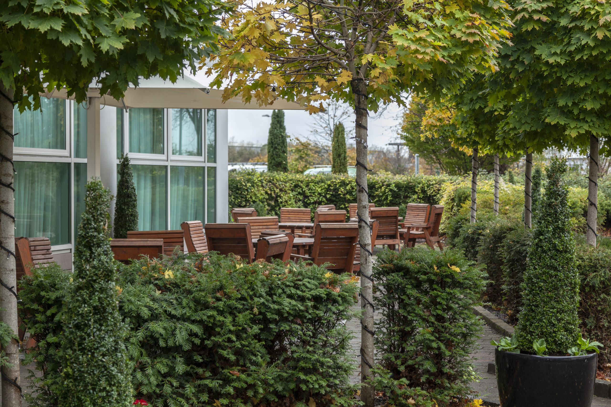 Outdoor terrace seating area at Radisson Royal Suites surrounded by landscaped gardens